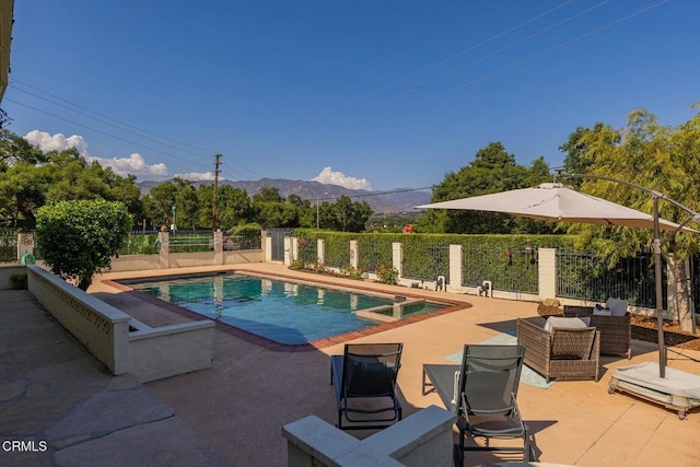 view of pool with a mountain view and a patio area