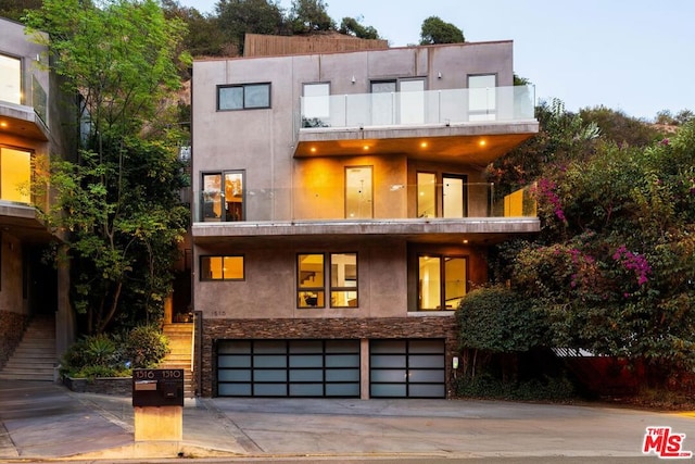 modern home with a garage and a balcony