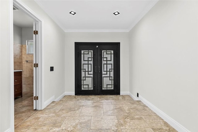 foyer featuring ornamental molding and french doors