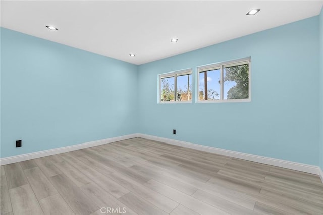 spare room featuring light hardwood / wood-style flooring