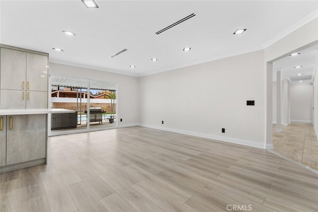 unfurnished living room featuring crown molding and light hardwood / wood-style floors