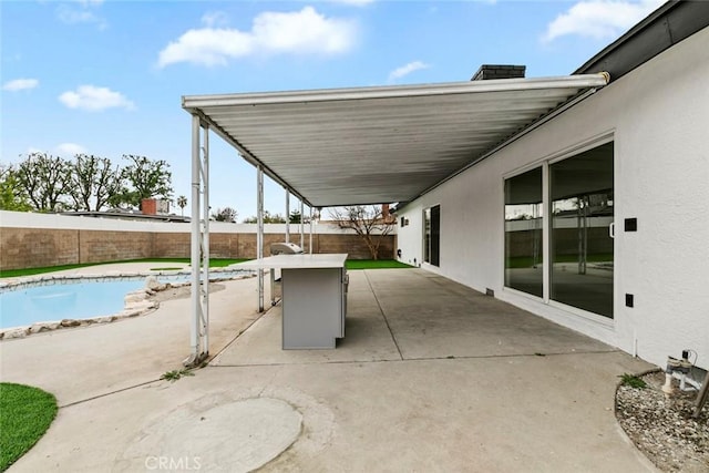 view of patio / terrace with a fenced in pool