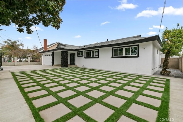 ranch-style home featuring a garage