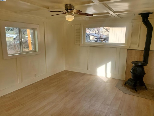 unfurnished room featuring ceiling fan, plenty of natural light, coffered ceiling, and light wood-type flooring