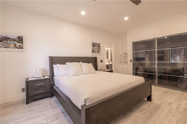 bedroom featuring ceiling fan and light wood-type flooring