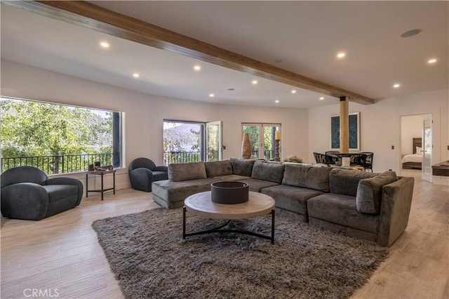 living room with beam ceiling and light hardwood / wood-style floors