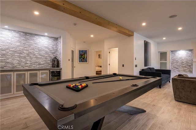 game room featuring wine cooler, pool table, beam ceiling, and light hardwood / wood-style floors