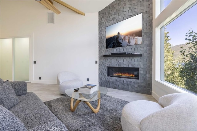 living room featuring a fireplace and beam ceiling