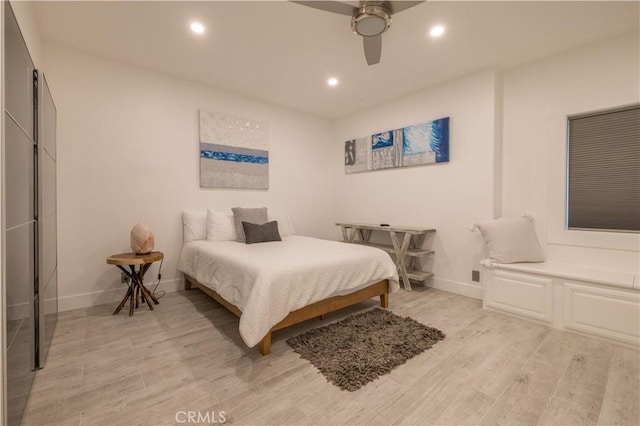 bedroom with ceiling fan and light wood-type flooring