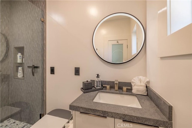 bathroom with walk in shower and vanity