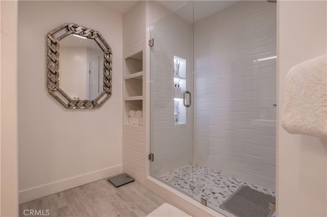 bathroom with hardwood / wood-style floors and walk in shower