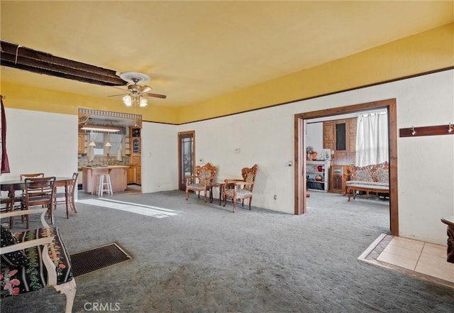 living room featuring ceiling fan and light colored carpet