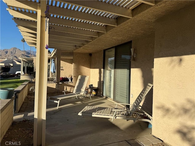 view of patio / terrace featuring a pergola and a mountain view