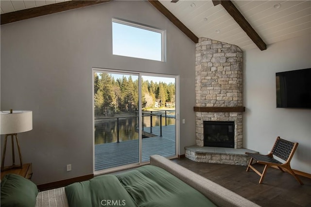 living room featuring wood-type flooring, a fireplace, high vaulted ceiling, and beam ceiling