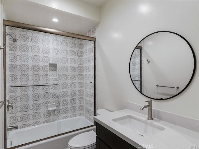 full bathroom with vanity, toilet, and combined bath / shower with glass door