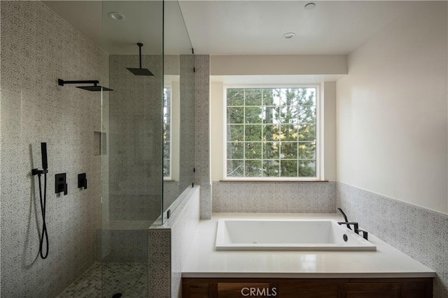 bathroom featuring sink and independent shower and bath