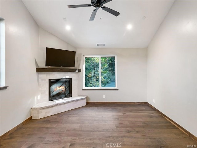 unfurnished living room featuring vaulted ceiling, ceiling fan, and dark hardwood / wood-style flooring