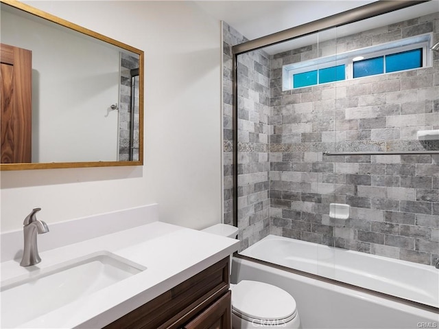 full bathroom featuring bath / shower combo with glass door, vanity, and toilet