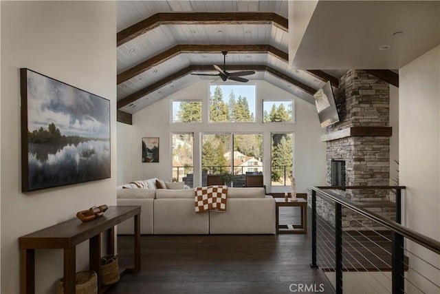 living room featuring a fireplace, high vaulted ceiling, dark hardwood / wood-style floors, ceiling fan, and beam ceiling