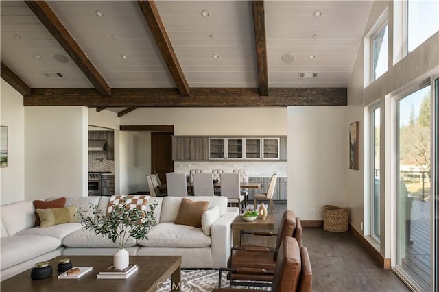 living room featuring hardwood / wood-style floors and lofted ceiling with beams