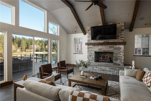 living room with vaulted ceiling with beams, wooden ceiling, ceiling fan, a fireplace, and hardwood / wood-style floors