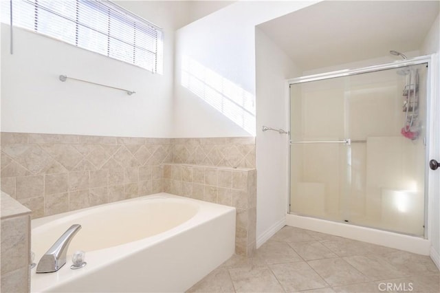 bathroom featuring independent shower and bath and tile patterned floors