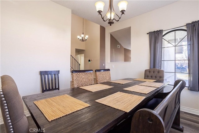 dining area featuring dark hardwood / wood-style floors and a chandelier