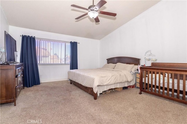 bedroom featuring vaulted ceiling, light carpet, and ceiling fan