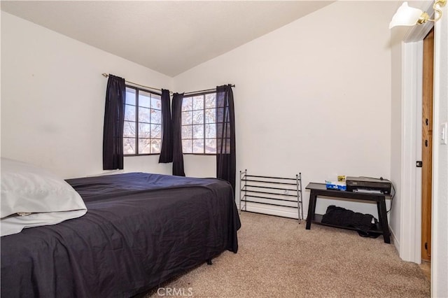 bedroom featuring vaulted ceiling and light carpet