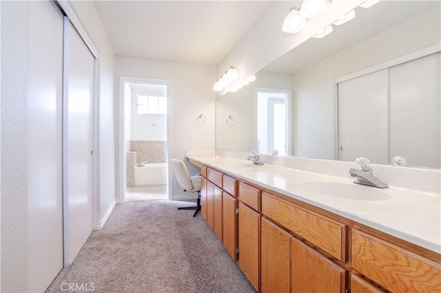 bathroom featuring vanity and a washtub