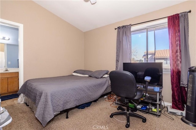 bedroom with connected bathroom and vaulted ceiling