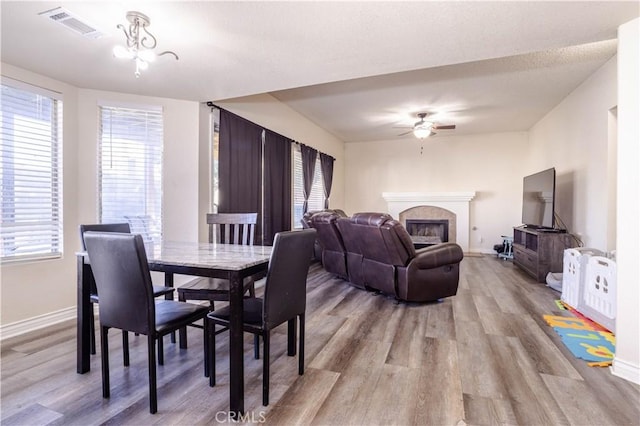 dining area with ceiling fan and light wood-type flooring