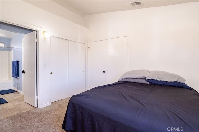 carpeted bedroom with ensuite bath