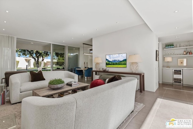 living room featuring indoor bar, beverage cooler, and light tile patterned floors