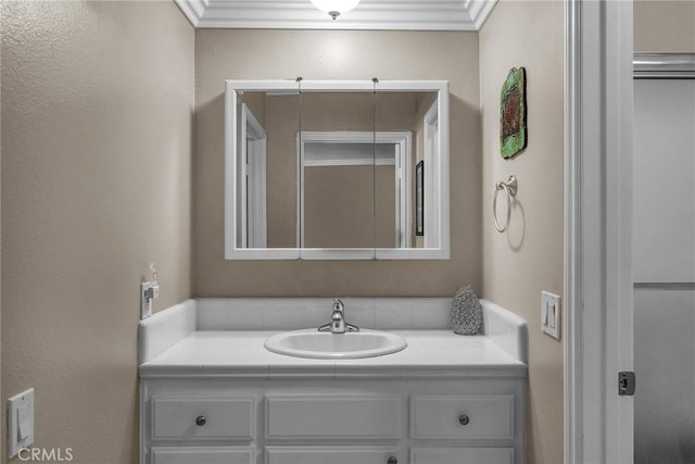 bathroom featuring crown molding and vanity