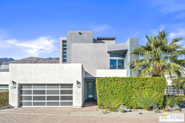 view of front of house with a garage and a mountain view