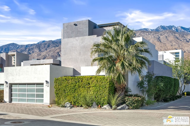 exterior space with a garage and a mountain view