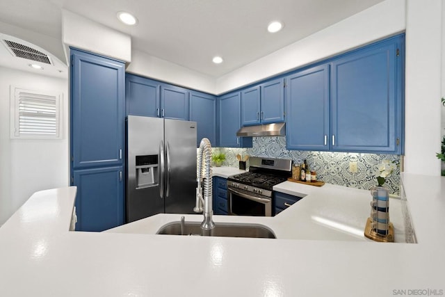 kitchen featuring appliances with stainless steel finishes, blue cabinets, sink, and decorative backsplash