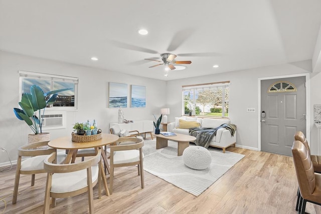 living room featuring cooling unit, ceiling fan, and light wood-type flooring