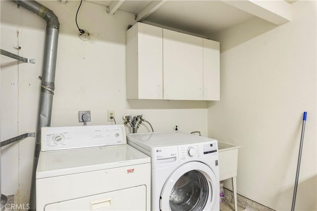 laundry area with cabinets and washing machine and clothes dryer