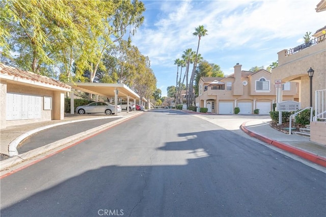 view of street featuring a residential view, curbs, and sidewalks