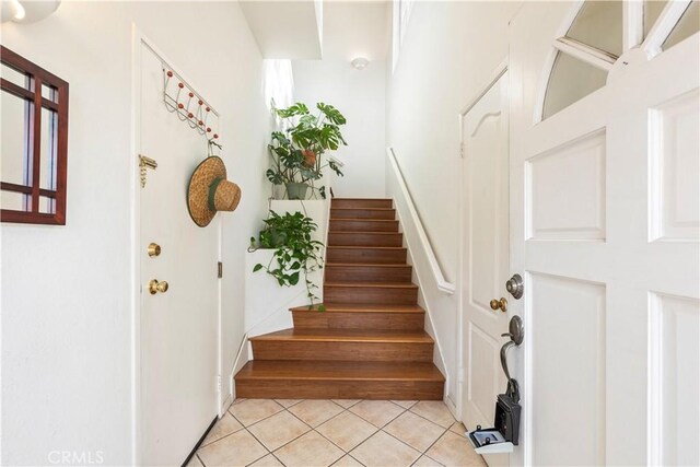 stairs featuring tile patterned flooring