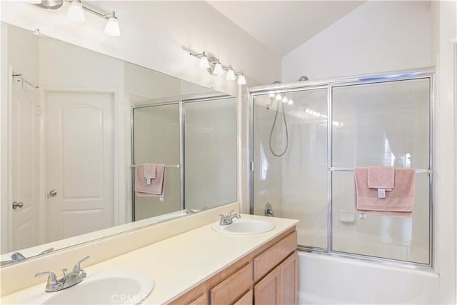 bathroom with a sink, enclosed tub / shower combo, double vanity, and vaulted ceiling