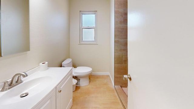 bathroom with vanity, tile patterned flooring, toilet, and walk in shower