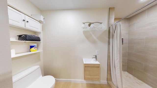 bathroom with vanity, toilet, curtained shower, and hardwood / wood-style floors