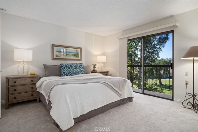 bedroom featuring carpet floors and access to outside