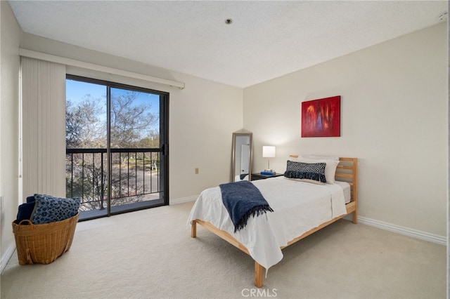 carpeted bedroom featuring access to exterior