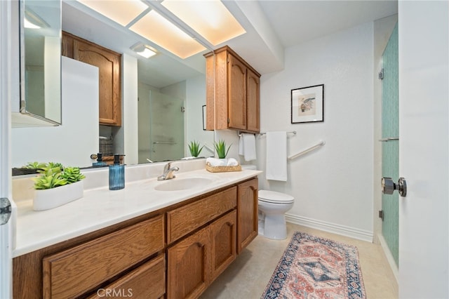 bathroom featuring vanity, a shower with shower door, and toilet