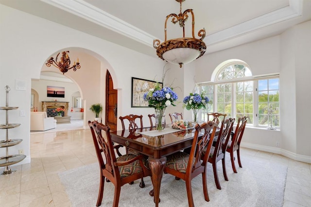 dining area featuring crown molding, a wealth of natural light, and a tray ceiling