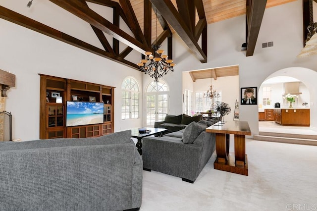 living room featuring an inviting chandelier, high vaulted ceiling, beamed ceiling, and carpet